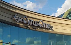 The CyrusOne logo, framed by clouds, on one of the company’s data centers. (Photo: Rich Miller)