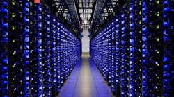 A blue-lit row of servers in a Google data center, (Photo: Google)