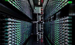 An early example of data center automation is this tape library in a Google data center in South Carolina, where robotic arms (visible at the end of the aisle) load and unload tapes.